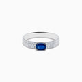 The Royal Bleu 14K White Gold Sapphire and Diamond Ring showcases an oval blue sapphire centerpiece with rows of small diamonds along the band, all set against a plain white background.