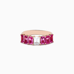 The 14k Rose Gold Pink and White Sapphire Ring features a central rectangular white sapphire, flanked by rectangular pink sapphires on each side, all set in rose gold and displayed against a white background.