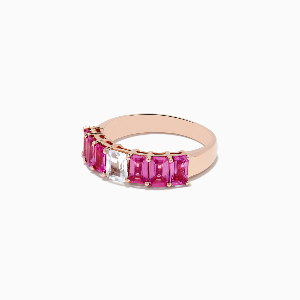 The 14k Rose Gold Pink and White Sapphire Ring features a central rectangular white sapphire, flanked by rectangular pink sapphires on each side, all set in rose gold and displayed against a white background.