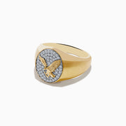 The 14K Yellow Gold Diamond Eagle Signet Ring features a round face with a raised eagle in flight set against sparkling diamond-like white stones.