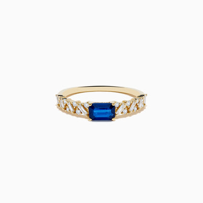 The 14K Yellow Gold Sapphire and Diamond Ring features a square-cut sapphire center with baguette and round-cut diamonds on the band, shown against a white background.
