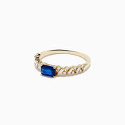 The 14K Yellow Gold Sapphire and Diamond Ring features a square-cut sapphire center with baguette and round-cut diamonds on the band, shown against a white background.