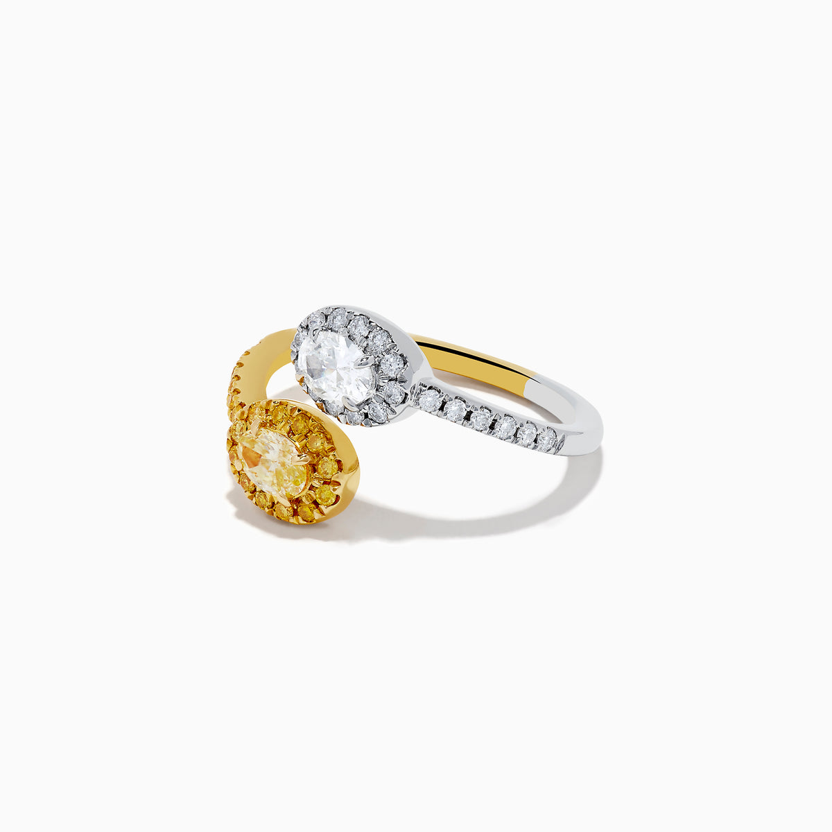 The Duo 14K 2-Tone Gold Yellow and White Diamond Toi Et Moi Ring features a white diamond surrounded by smaller diamonds on silver, and a yellow diamond accented by yellow stones on a 14K gold band, shown against a white background.
