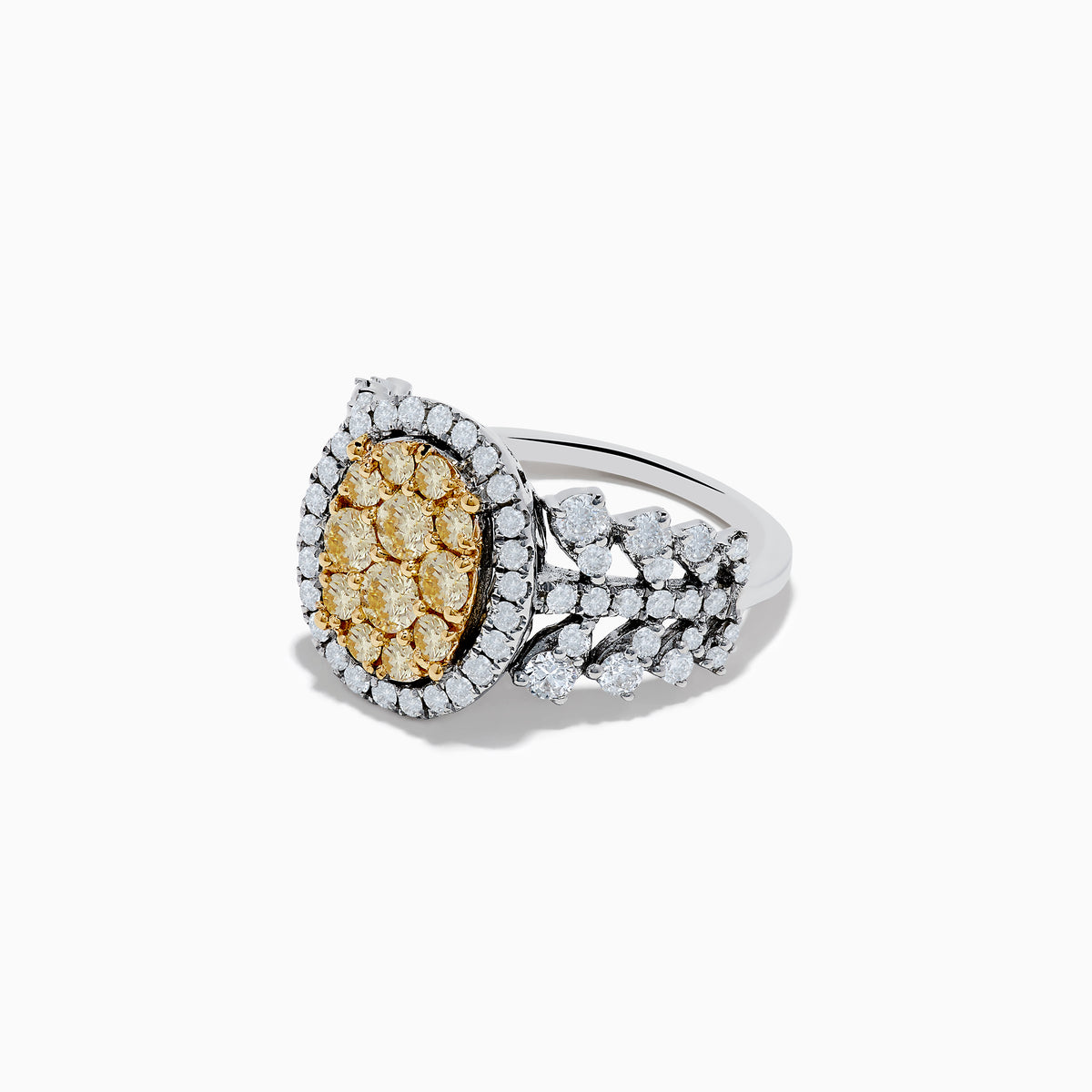 The Canare 14K Two Tone White and Yellow Diamond Ring showcases an oval cluster of yellow diamonds, accented by a white diamond halo and band in a striking multi-row design.