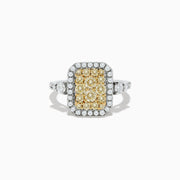 The Canare` 14K Two Tone Gold White and Yellow Diamond Ring showcases a cluster of yellow diamonds at the center, surrounded by white diamonds on a rectangular band.