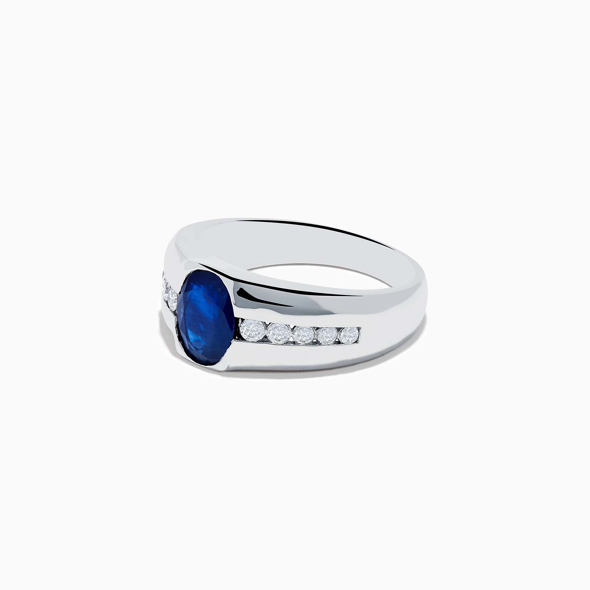 The Mens 14K White Gold Sapphire and Diamond Ring features a large oval blue sapphire at the center, accented on each side by rows of small round white diamonds set into the stylish band.