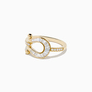The Novelty 14K Yellow Gold Diamond Horseshoe Ring features baguette-cut diamonds and two small gold spheres at each end, elegantly displayed on a white background.
