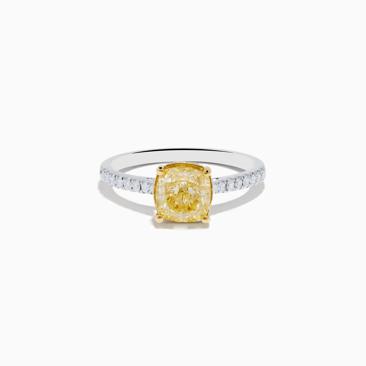 The Canare 18K Two Tone Gold Yellow and White Diamond Ring features a cushion-cut yellow diamond center held by gold prongs, accented with sparkling white diamonds along the band.