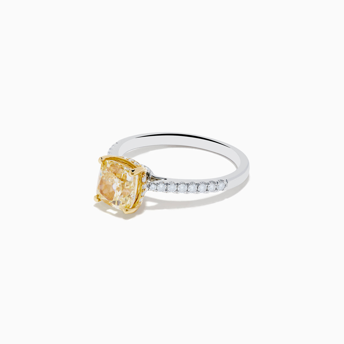 The Canare 18K Two Tone Gold Yellow and White Diamond Ring features a cushion-cut yellow diamond center held by gold prongs, accented with sparkling white diamonds along the band.