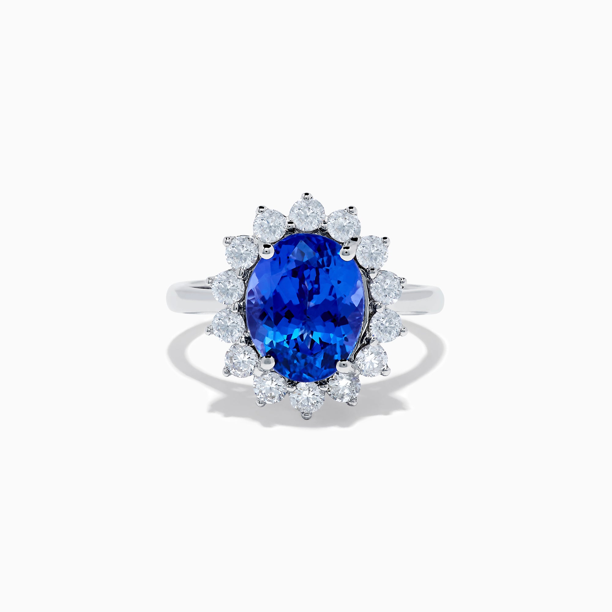 The Nahla Siri 14K White Gold Tanzanite and Diamond Ring showcases a large oval tanzanite center stone encircled by a halo of sparkling round white diamonds, all set in radiant 14K white gold.