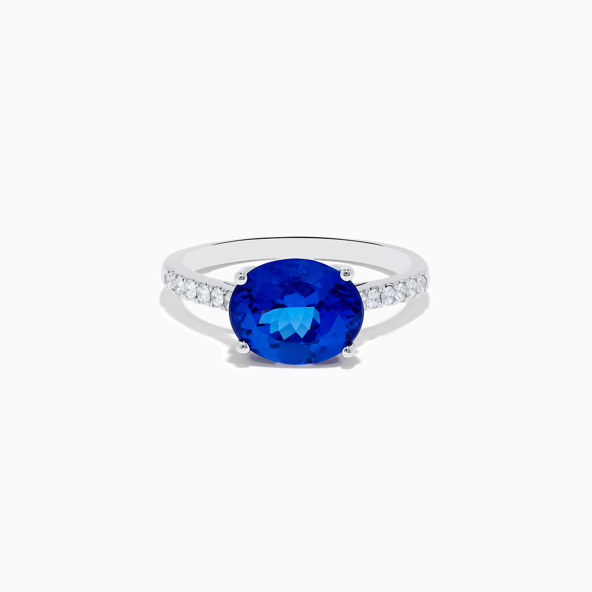 The Nahla Siri 14K White Gold Tanzanite and Diamond Ring features a large oval tanzanite center stone with smaller diamonds along the band, shown against a plain white background.