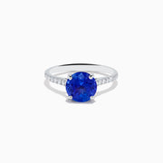 The Nahla 14K White Gold Round Tanzanite and Diamond Ring features a central tanzanite gemstone accented by diamonds along the band, shown against a white background.