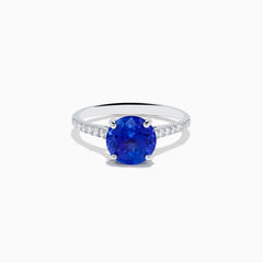 The Nahla 14K White Gold Round Tanzanite and Diamond Ring features a central tanzanite gemstone accented by diamonds along the band, shown against a white background.