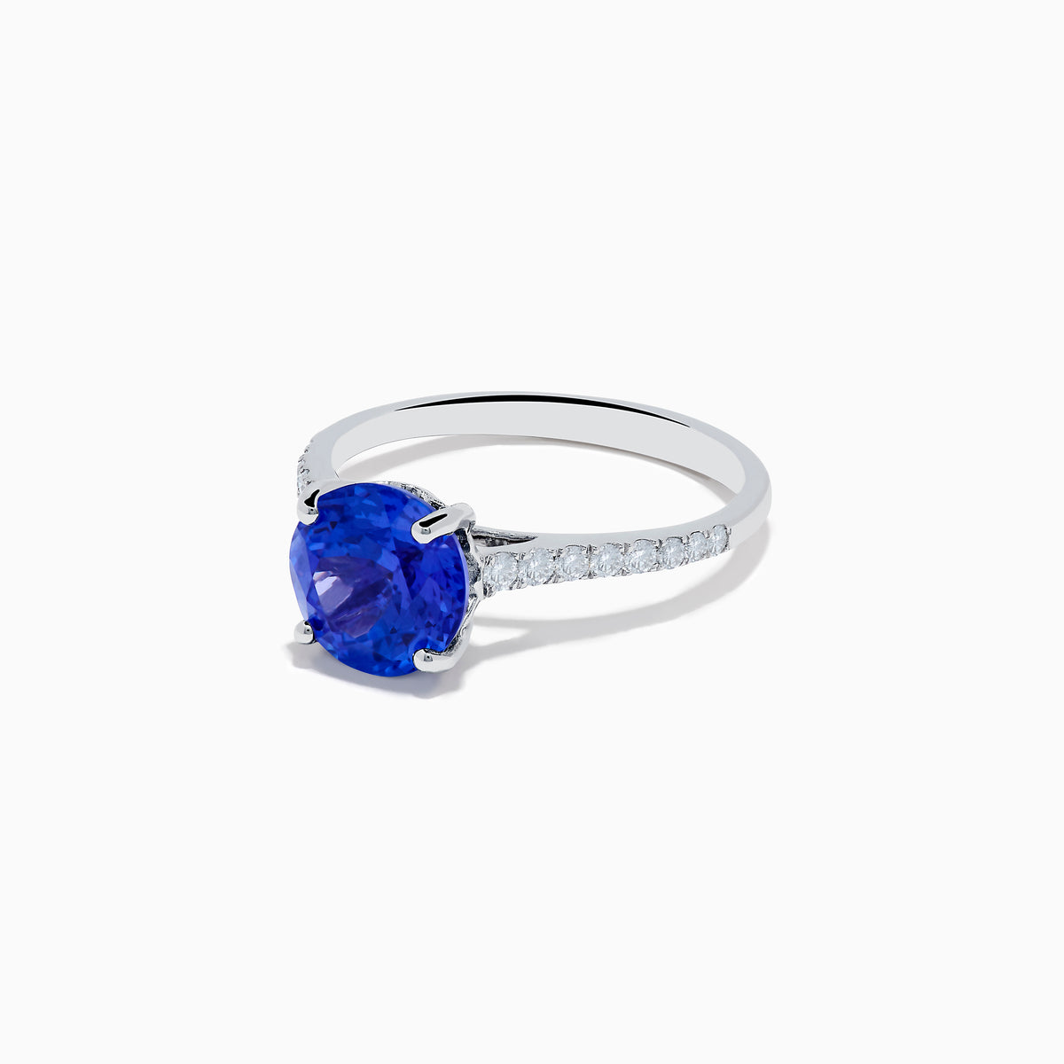 The Nahla 14K White Gold Round Tanzanite and Diamond Ring features a central tanzanite gemstone accented by diamonds along the band, shown against a white background.