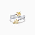 The Canare 18K Two Tone White and Yellow Diamond Bypass Ring features a spiral design with a row of small white diamonds, highlighted by yellow cushion-cut and pear-shaped diamonds set in yellow gold prongs.