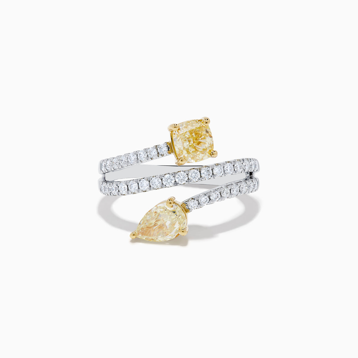 The Canare 18K Two Tone White and Yellow Diamond Bypass Ring features a spiral design with a row of small white diamonds, highlighted by yellow cushion-cut and pear-shaped diamonds set in yellow gold prongs.