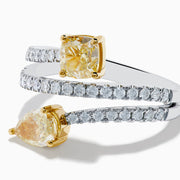 The Canare 18K Two Tone White and Yellow Diamond Bypass Ring features a spiral design with a row of small white diamonds, highlighted by yellow cushion-cut and pear-shaped diamonds set in yellow gold prongs.