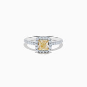 The Canare 18K Two Tone Gold White and Yellow Diamond Ring showcases a cushion-cut yellow diamond center, haloed by white diamonds, with a diamond-adorned band.