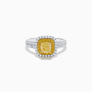 The Canare 18K Two Tone White and Yellow Diamond Ring showcases a square yellow center stone, encircled by yellow and white diamond halos, set on a band adorned with sparkling clear diamonds.