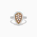 The 14K Two Tone Gold White and Pink Diamond Ring features a teardrop shape with a rose gold center set with white diamonds, surrounded by a halo and band of more white diamonds for a polished, elegant look.