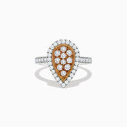 The 14K Two Tone Gold White and Pink Diamond Ring features a teardrop shape with a rose gold center set with white diamonds, surrounded by a halo and band of more white diamonds for a polished, elegant look.