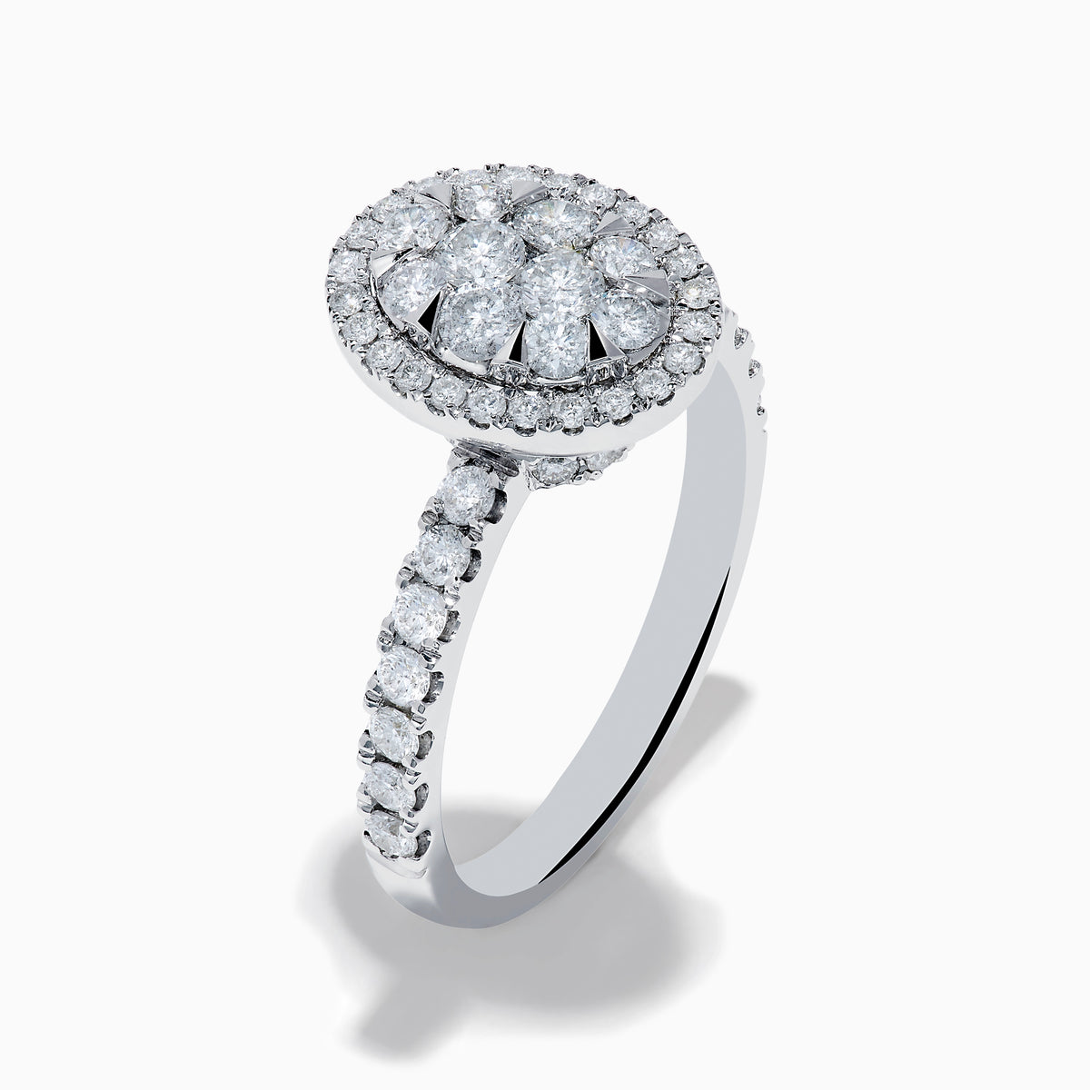 The Bouquet 14K White Gold Diamond Cluster Ring showcases an oval diamond cluster with a double halo of sparkling diamonds and extra diamonds set along the band.