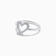 The Novelty 14K White Gold Heart Ring features an open-heart design adorned with sparkling diamonds, shown against a plain white background.