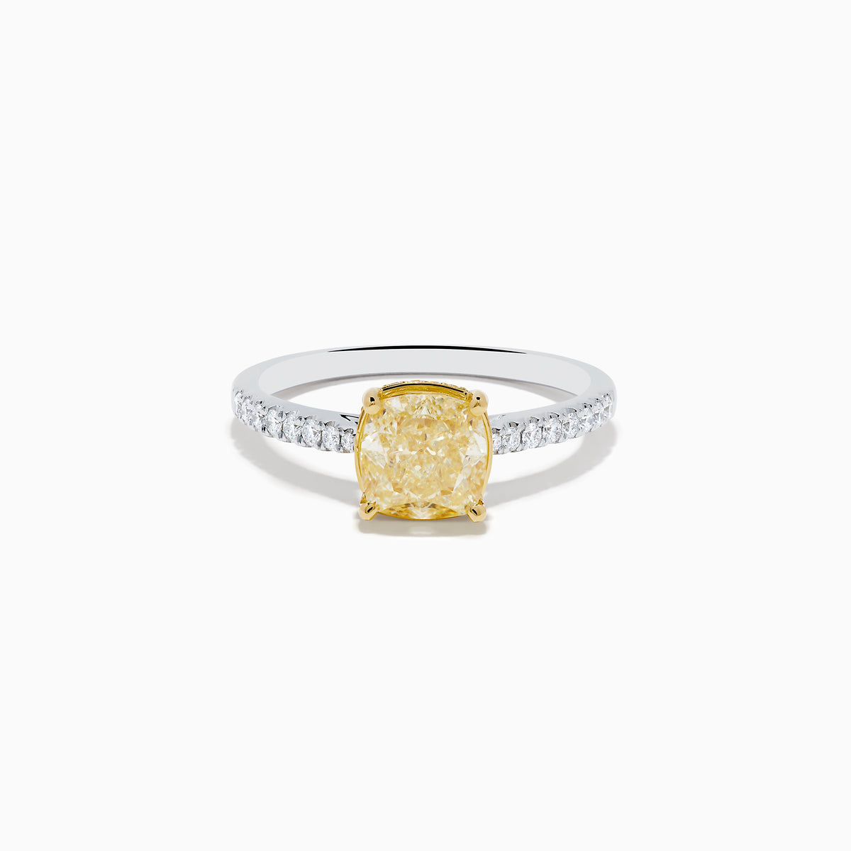 The Canare 18K Two Tone White and Yellow Diamond Ring features a cushion-cut yellow diamond centerpiece accented by small round white diamonds along the band.