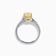 The Canare 18K Two Tone White and Yellow Diamond Ring features a cushion-cut yellow diamond centerpiece accented by small round white diamonds along the band.