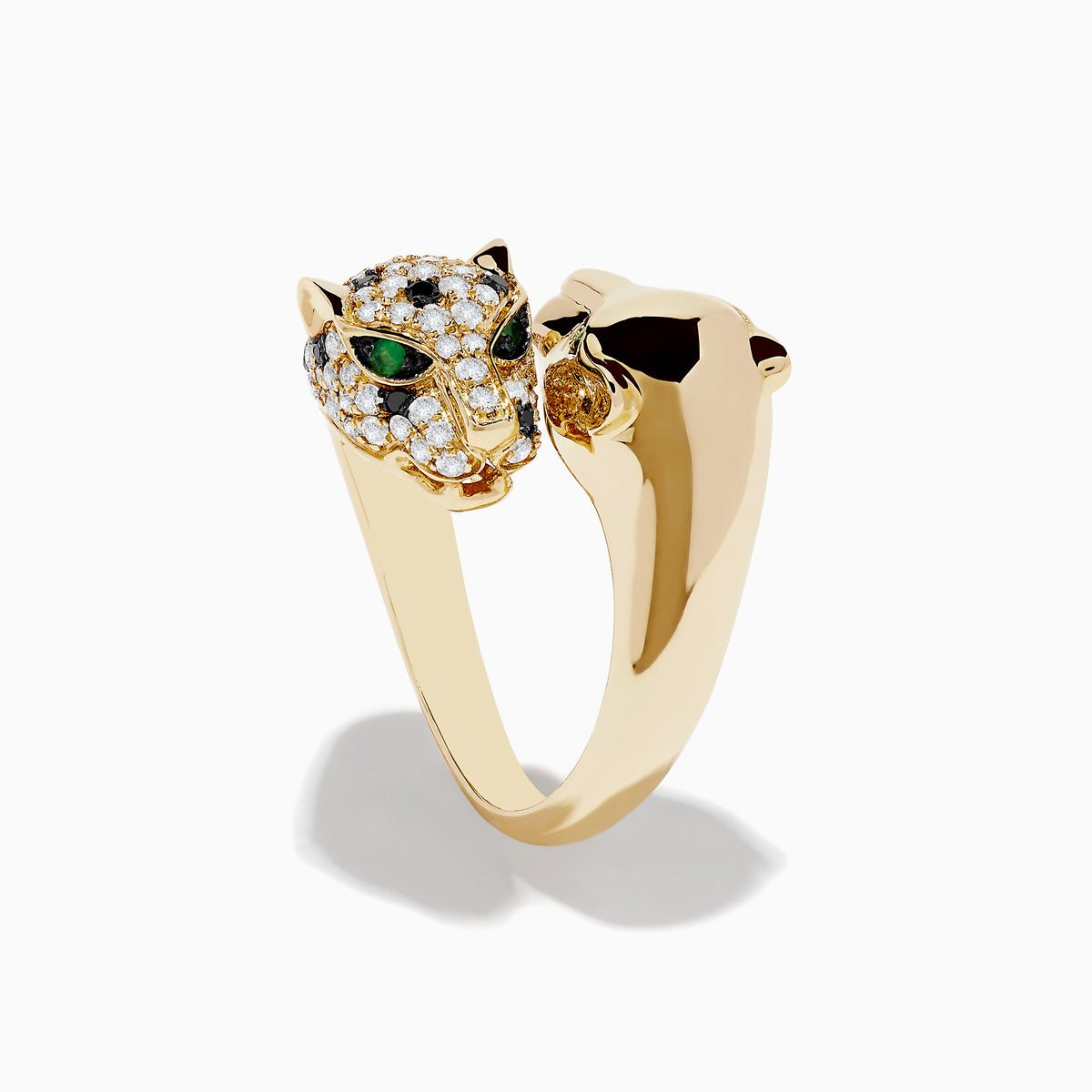 The Signature 14K Yellow Gold Diamond and Emerald Double Panther Ring showcases two panther heads—one with smooth gold and emerald-green gem eyes, the other adorned with sparkling diamonds and black gemstones—set on a white background.