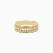 The Mens 14K Yellow Gold Diamond Ring features a central row of small round diamonds set in a channel, accented by delicate engraved details on each side.