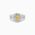 The 18K Two-Tone Gold Yellow Diamond Oval Halo Ring 1.63 TCW features a dazzling oval yellow diamond center with a halo and split shank band adorned with sparkling diamonds—a timeless, elegant design.