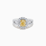 The 18K Two-Tone Gold Yellow Diamond Oval Halo Ring 1.63 TCW features a dazzling oval yellow diamond center with a halo and split shank band adorned with sparkling diamonds—a timeless, elegant design.