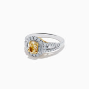 The 18K Two-Tone Gold Yellow Diamond Oval Halo Ring 1.63 TCW features a dazzling oval yellow diamond center with a halo and split shank band adorned with sparkling diamonds—a timeless, elegant design.
