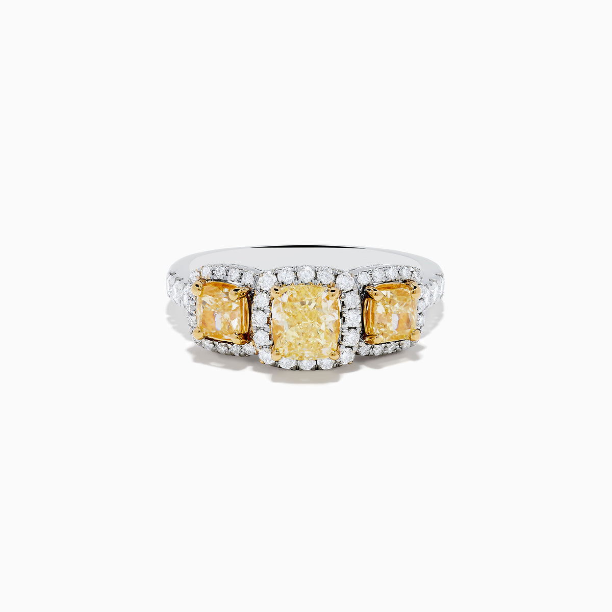 The Canare 18K Two Tone White and 3 Stone Yellow Diamond Ring showcases three rectangular yellow diamonds, each haloed with sparkling diamonds, set on a diamond-studded white gold band.