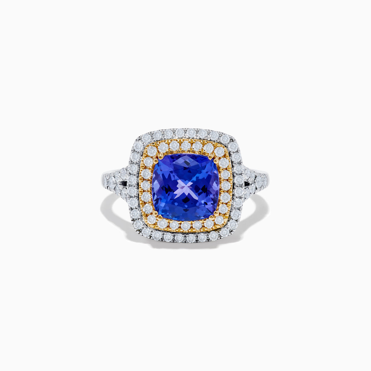 The Nahla Siri 14K Two Tone Gold Tanzanite and Diamond Ring features a large cushion-cut tanzanite center, encircled by a halo of yellow stones and an outer halo of sparkling diamonds.