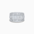 The 14K White Gold Diamond Wide Band Statement Ring showcases multiple rows of closely set round white diamonds, creating a dazzling and luxurious look against its wide, polished band. The background is plain white.