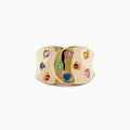 The Watercolors 14K Yellow Gold Multi Color Sapphire Ring features a wide, wavy yellow gold band set with blue, green, red, pink, and yellow sapphires for a vibrant watercolor effect against a plain white background.