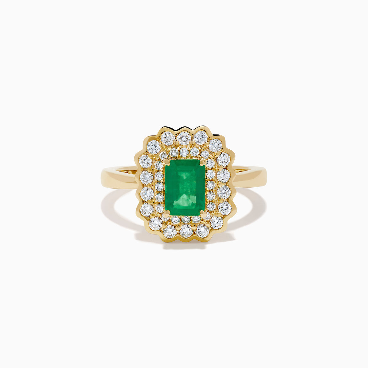 The Brasilica 14K Yellow Gold Emerald and Diamond Double Halo Ring showcases a rectangular green emerald at the center, accented by two rows of sparkling round white diamonds in an elegant scalloped halo design.