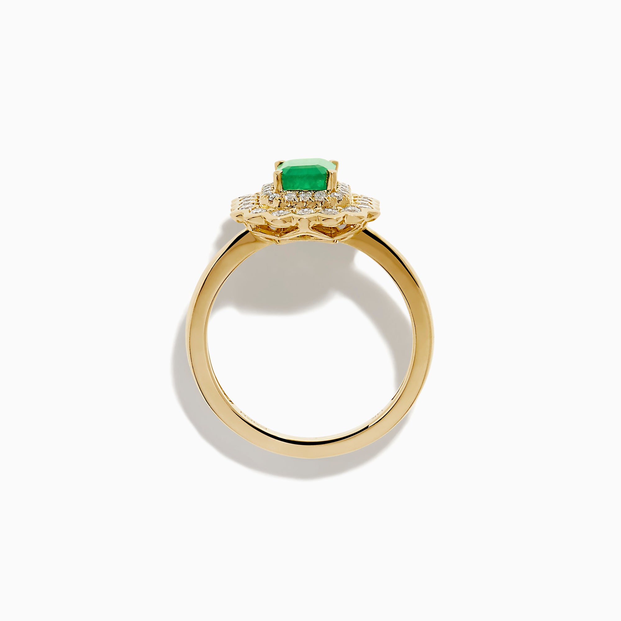 The Brasilica 14K Yellow Gold Emerald and Diamond Double Halo Ring showcases a rectangular green emerald at the center, accented by two rows of sparkling round white diamonds in an elegant scalloped halo design.