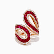 The 14K Rose Gold Ruby and Diamond Bypass Statement Ring features two overlapping rose gold loops adorned with rows of rubies and bordered by sparkling diamonds, creating an elegant and luxurious look against a plain white background.