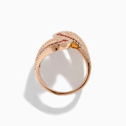 The 14K Rose Gold Ruby and Diamond Bypass Statement Ring features two overlapping rose gold loops adorned with rows of rubies and bordered by sparkling diamonds, creating an elegant and luxurious look against a plain white background.