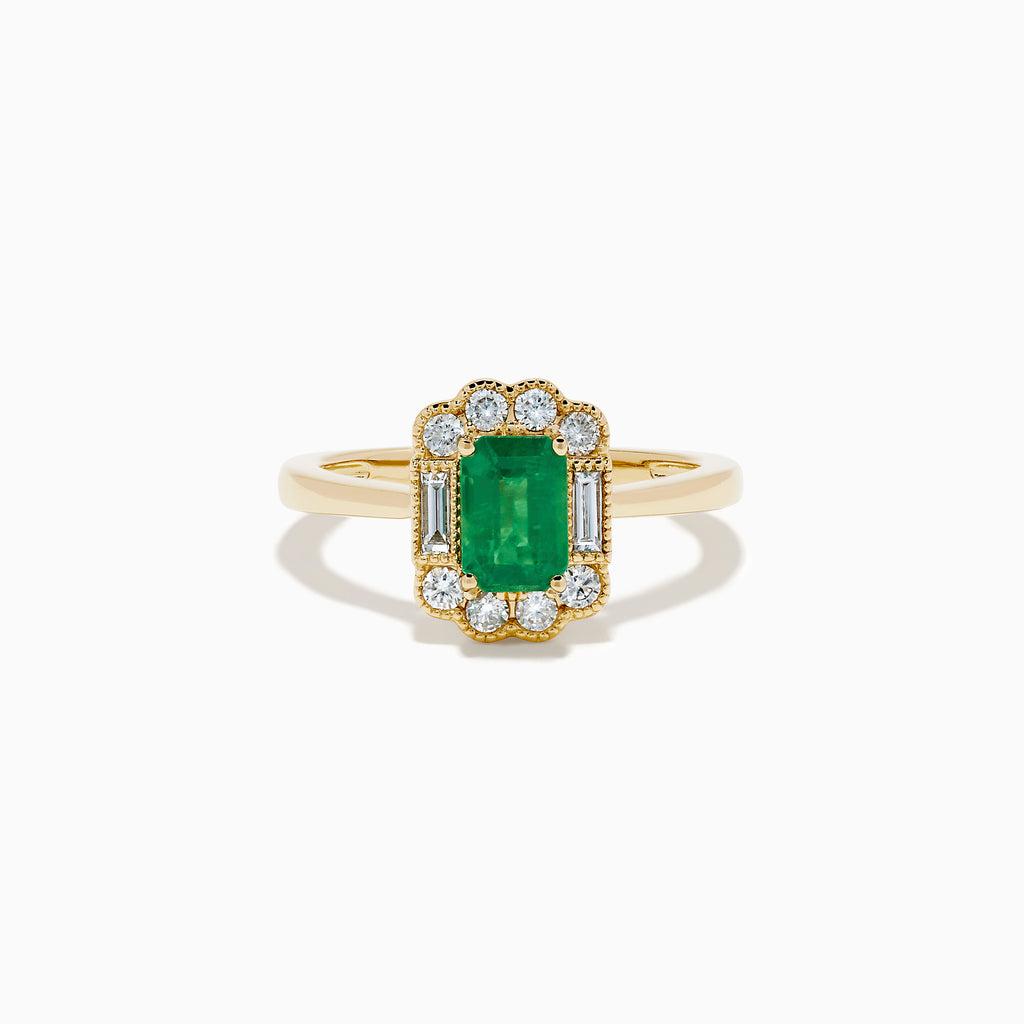 The 14K Yellow Gold Emerald and Diamond Halo Vintage Ring features an emerald-cut green center stone, accented by round and baguette white diamonds in a vintage halo setting.