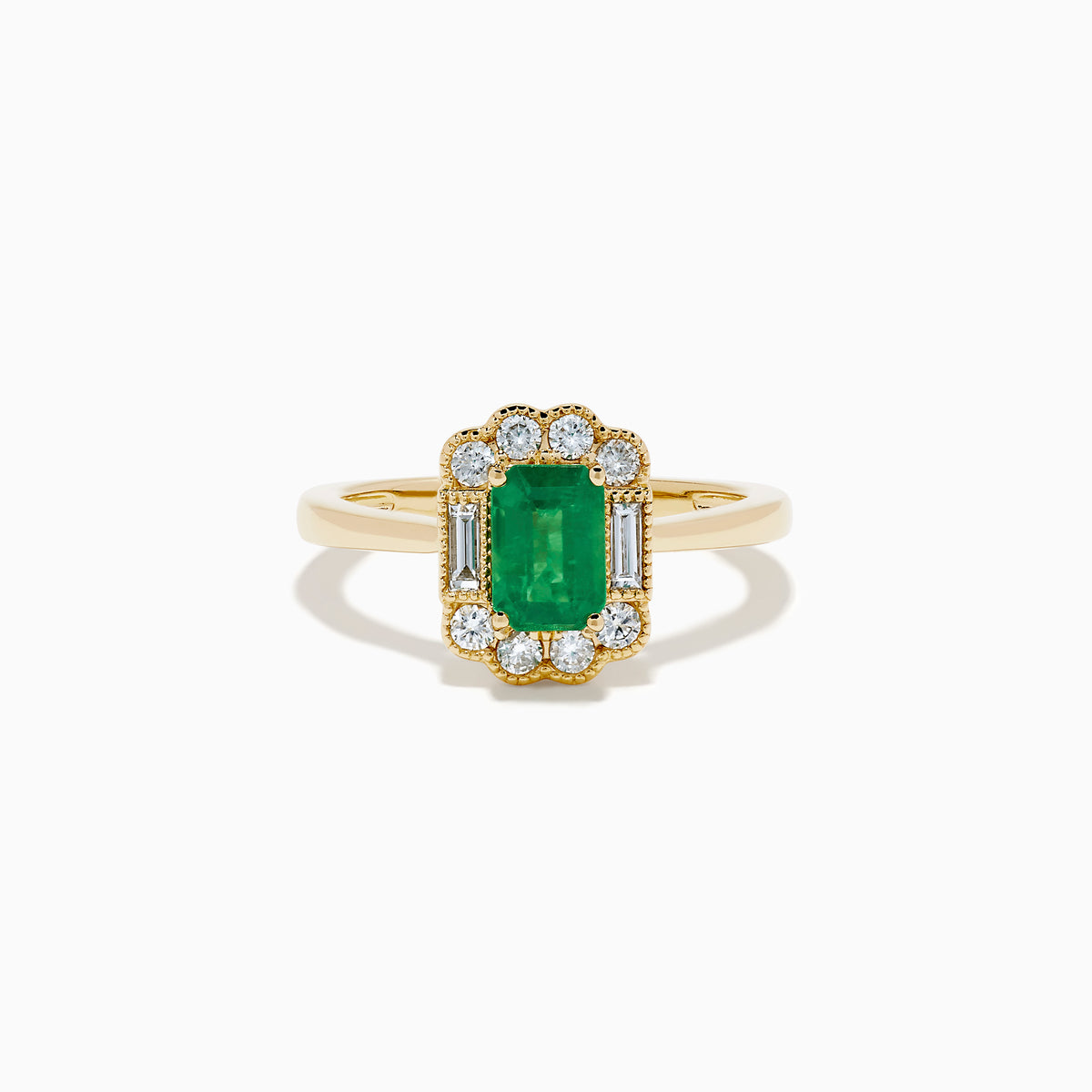 The 14K Yellow Gold Emerald and Diamond Halo Vintage Ring features an emerald-cut green center stone, accented by round and baguette white diamonds in a vintage halo setting.