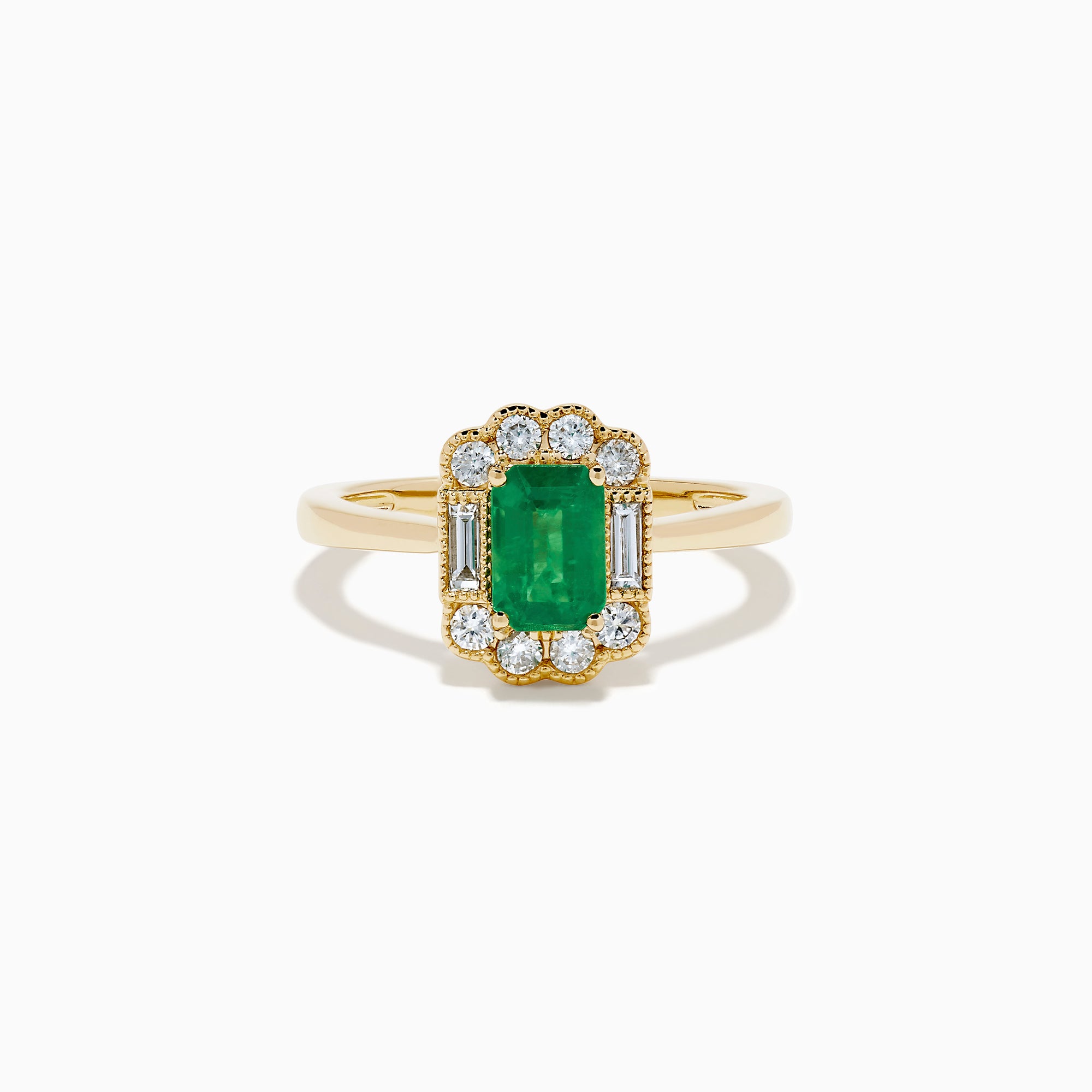 The 14K Yellow Gold Emerald and Diamond Halo Vintage Ring features an emerald-cut green center stone, accented by round and baguette white diamonds in a vintage halo setting.