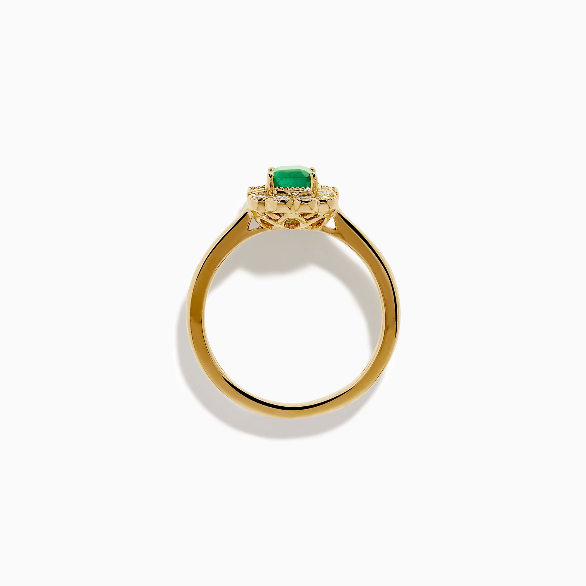 The 14K Yellow Gold Emerald and Diamond Halo Vintage Ring features an emerald-cut green center stone, accented by round and baguette white diamonds in a vintage halo setting.