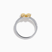The Canare 14K White & Yellow Gold Yellow Diamond Flower Ring features a four-petal design with yellow diamonds and a central clear stone, set on a slim band accented with small white stones.
