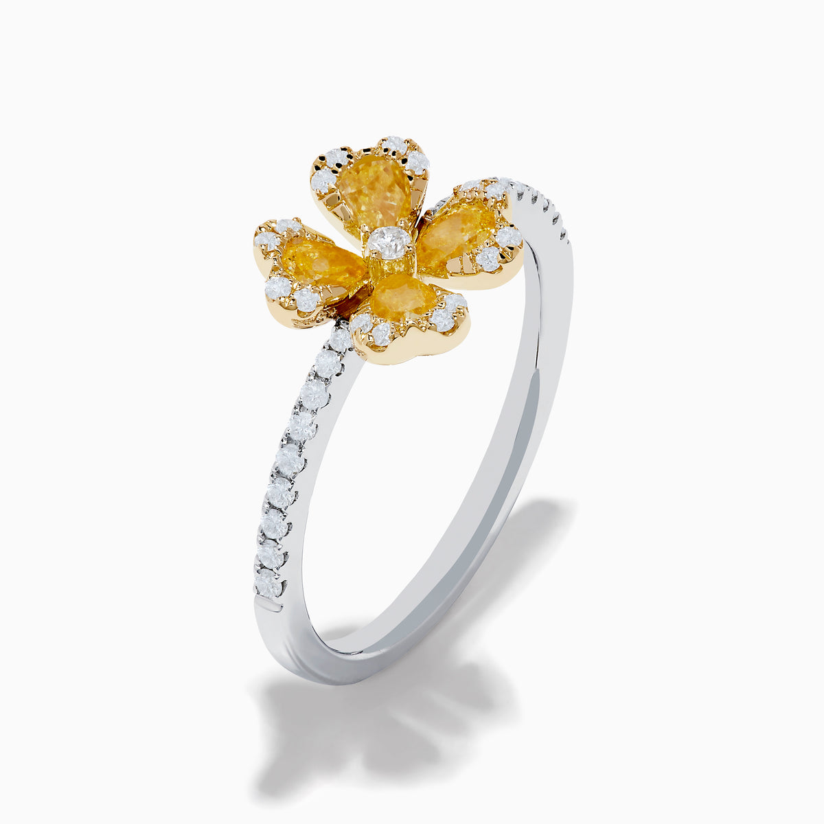The Canare 14K White & Yellow Gold Yellow Diamond Flower Ring features a four-petal design with yellow diamonds and a central clear stone, set on a slim band accented with small white stones.