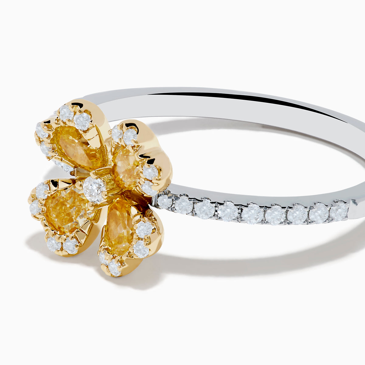 The Canare 14K White & Yellow Gold Yellow Diamond Flower Ring features a four-petal design with yellow diamonds and a central clear stone, set on a slim band accented with small white stones.