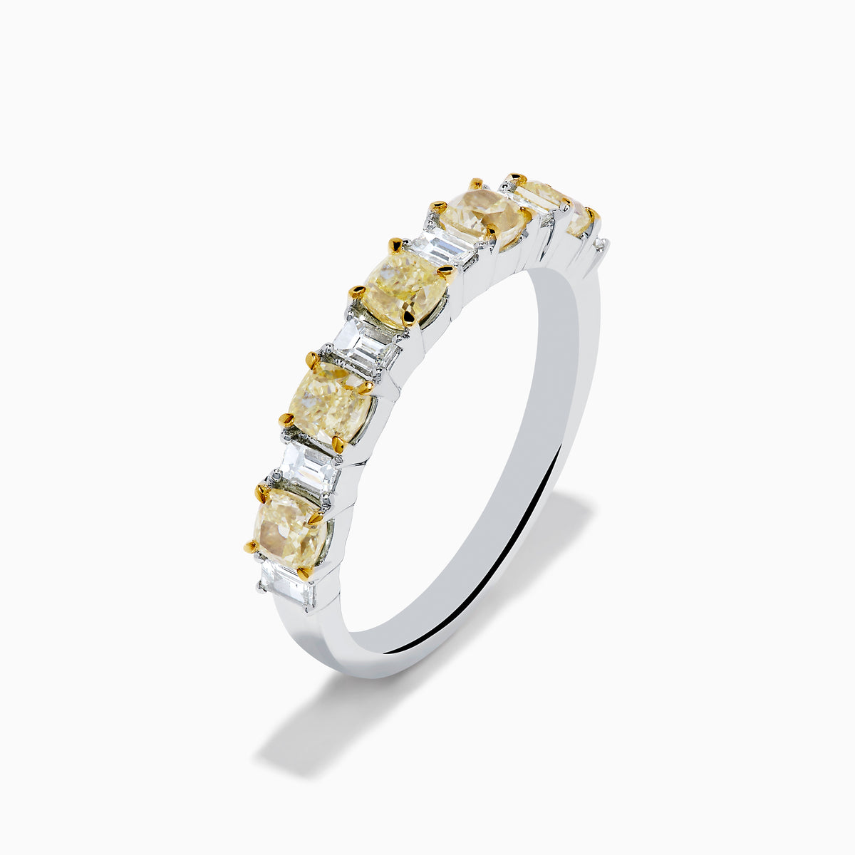 The Canare 18K Two Tone Gold White and Yellow Gold Diamond Band Ring features alternating rectangular yellow and clear diamonds set in a row along the band, shown on a white background.